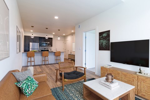 a living room with a couch and a table with a television